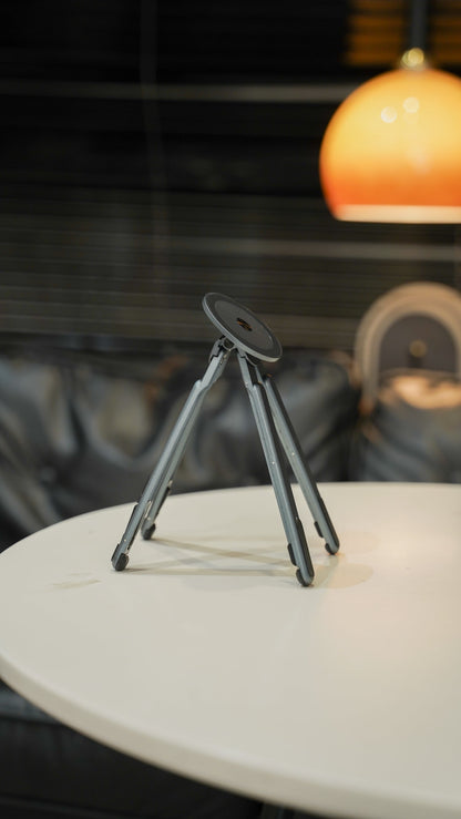 Foldnix magnetic stand folded flat on side table